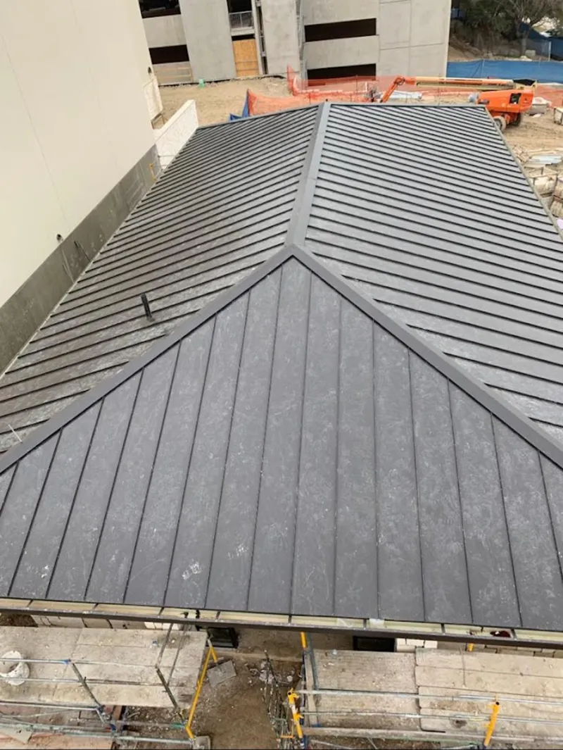 Commercial metal roof construction with crane equipment in Immokalee