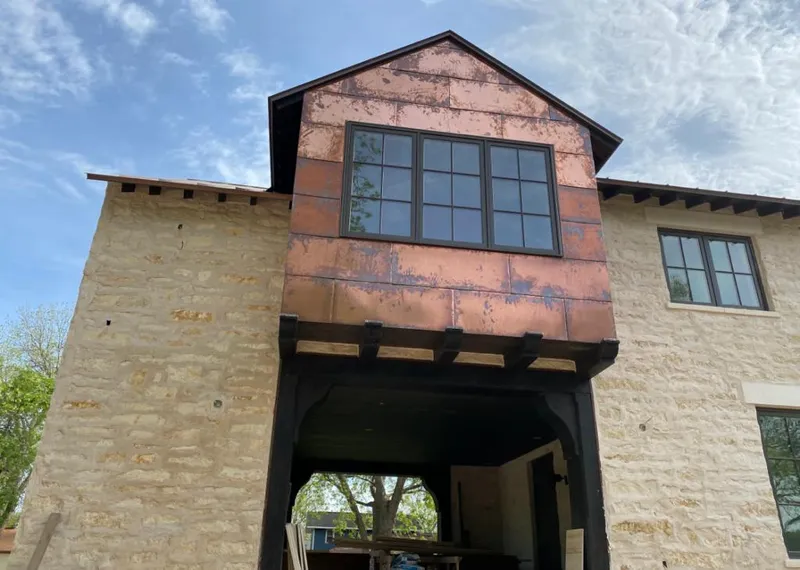 Copper metal panel facade on a stone building for Skylight Installation in Immokalee